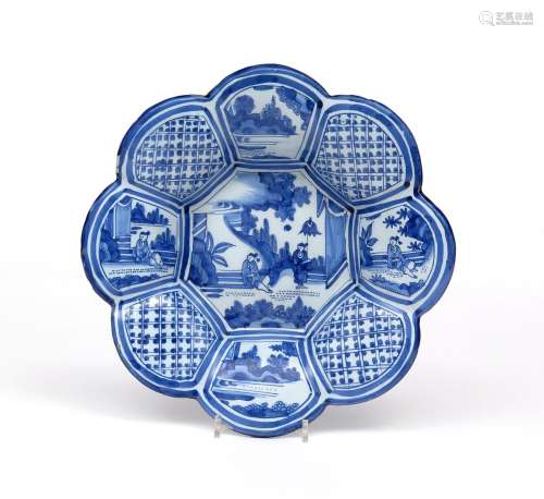 A Delft lobed dish c.1700, of rounded octagonal form, painted to the well with Chinese figures
