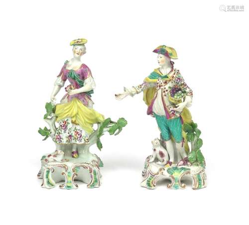 A pair of Derby figures of the Dresden Shepherds c.1765, he holding a basket of fruit and holding