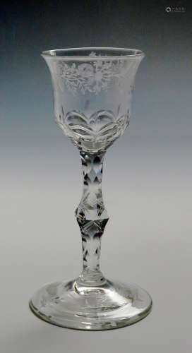 A wine glass of Jacobite type c.1765, the bowl engraved with a continuous band of flowers