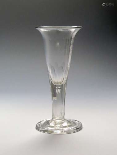 A large heavy ale glass c.1770, the drawn trumpet bowl with everted rim, rising from a thick faceted