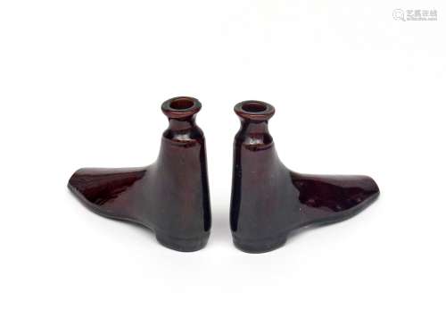 A pair of brown stoneware boot flasks c.1840, decorated in a rich treacle glaze, a line of moulded