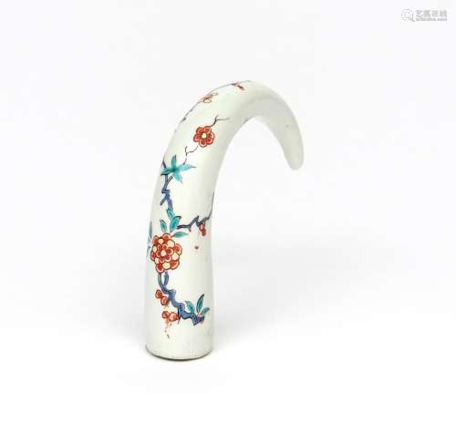 A Chantilly cane handle c.1735, the tapering curved form painted in Kakiemon enamels with a spray of
