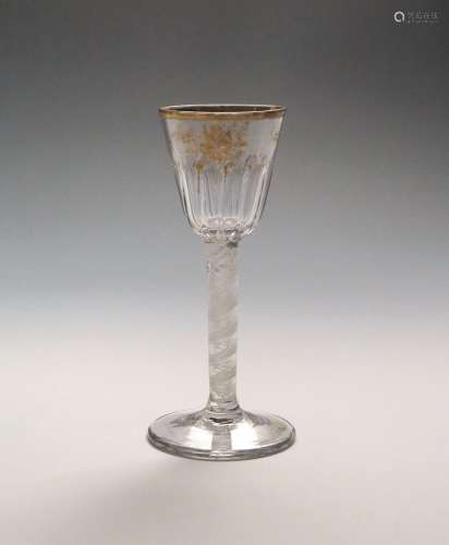 A Giles-decorated wine glass c.1770, the rounded funnel bowl moulded with twelve flutes and