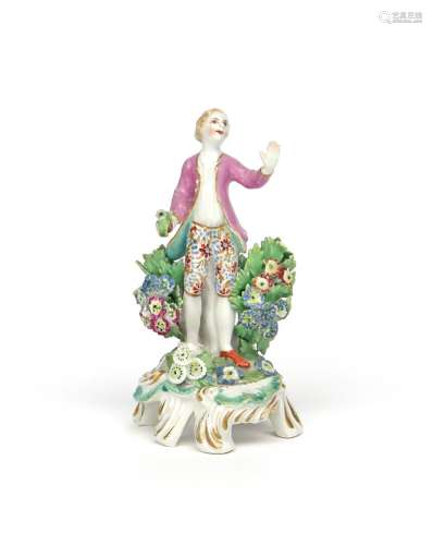 A rare Bow miniature figure of a boy c.1765, standing with his left hand outstretched, holding a