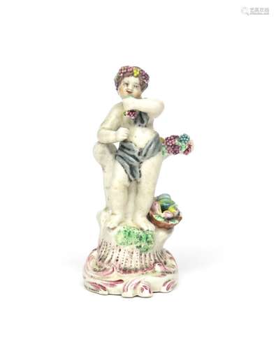 A Plymouth figure of Autumn c.1770, modelled as a putto standing on a tall scrolled base and holding