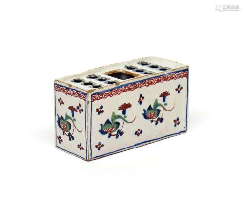 A small delftware polychrome flower brick c.1730-50, of rectangular form, painted in red, green