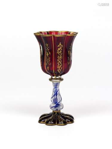 A Bohemian glass goblet 19th century, the fluted ruby glass bowl gilded with foliate scrolls, raised