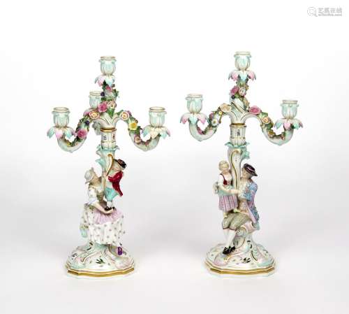 A pair of Meissen figural candelabra 19th century, each modelled with a gentleman and his