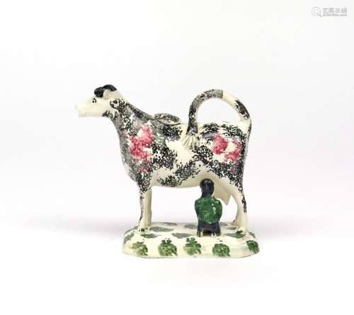 A pearlware cow creamer and cover c.1820, standing four square on a chamfered rectangular base, a