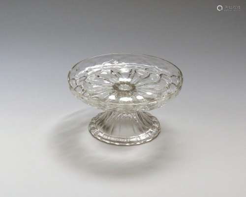 A low glass tazza or salver c.1730, the shallow tray with everted rim, moulded to the underside with
