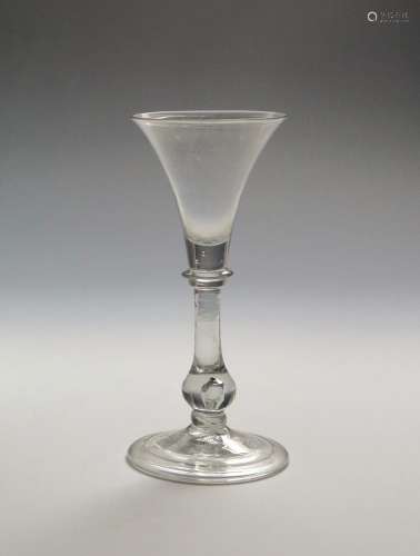 A light baluster glass c.1730, the flared bowl above a collar on a baluster stem enclosing a tear