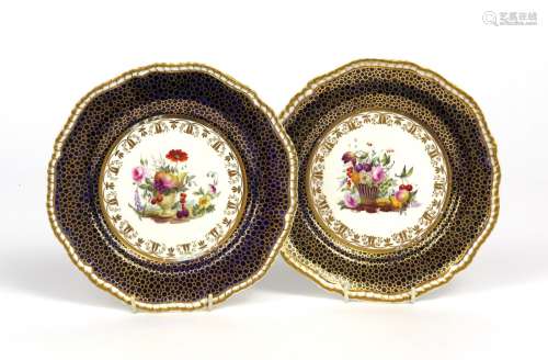 A pair of Spode dessert plates c.1810, the wells painted with urns spilling various fruit and