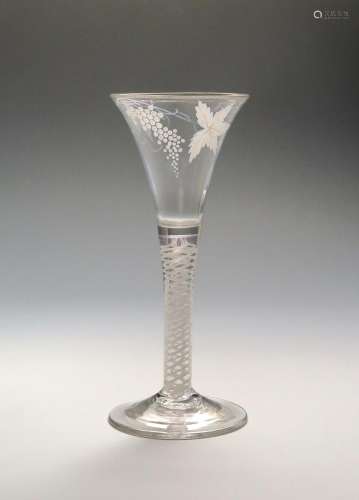 A tall Beilby wine glass c.1770, the generous drawn trumpet bowl enamelled in white with a spray