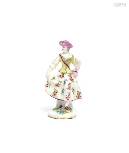 A rare Bow miniature figure of a lady c.1760, wearing a satchel slung over one shoulder and