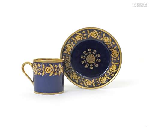 A Sèvres coffee can and saucer c.1825, decorated with a continuous formal flowerhead border in