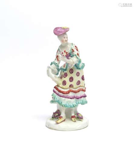 A Derby figure of a lady c.1765, holding a posy of flowers in her left hand, wearing a layered