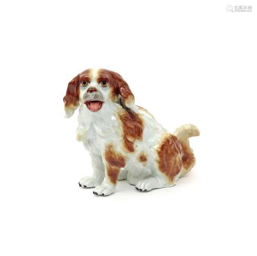 A Russian porcelain figure of a dog 19th century, Popov factory, seated on its haunches and