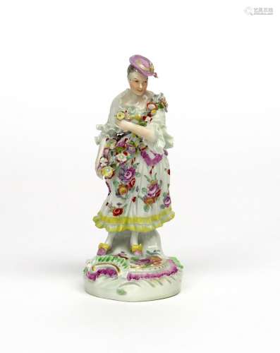 A Derby figure of a dancing shepherdess c.1758-60, a small posy in her extended left hand, a garland