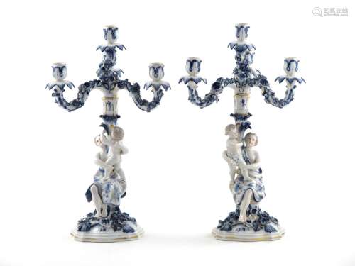 A pair of Thuringian porcelain candelabra 19th century, in the Meissen style, each modelled as a
