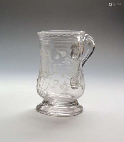 A glass mug or tankard dated 1775, the bell shaped body engraved with the initials 'A I W' above the