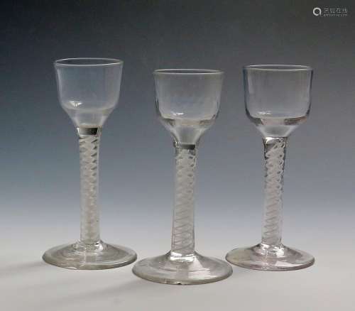 Three small wine glasses c.1760, two with plain ogee bowls, one with moulded vertical flutes to