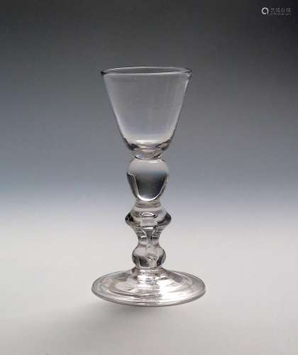 A light baluster cordial or small wine glass c.1725, the round funnel bowl supported on an egg
