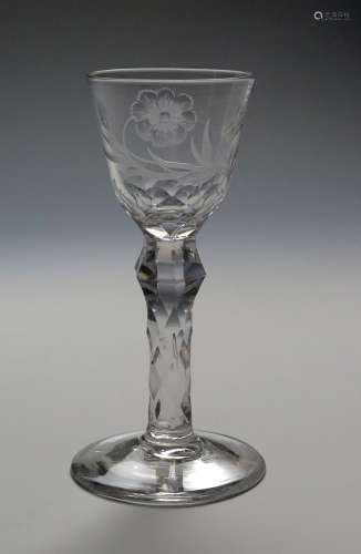 A good engraved wine glass c.1765, decorated with a flower spray and a single bee, raised on a six-
