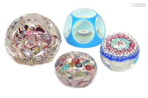 Four Continental glass paperweights 19th century, the largest Bohemian, faceted and set with