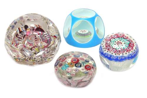 Four Continental glass paperweights 19th century, the largest Bohemian, faceted and set with