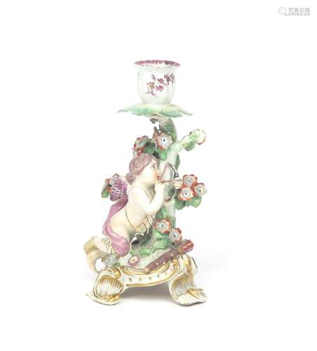A Chelsea candlestick figure c.1765, a winged putto kneeling before flowering bocage and pulling