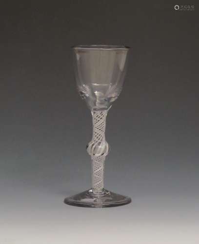 A large wine glass c.1760, with a generous ogee bowl raised on a knopped opaque twist stem above a