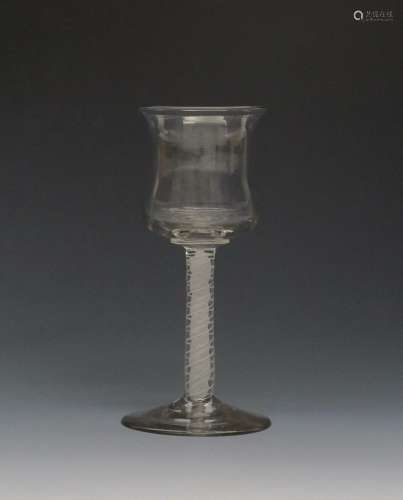 An unusual wine glass c.1765, with a generous tulip bowl on a double series opaque twist stem