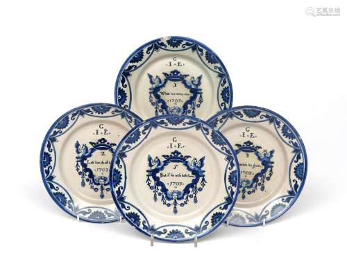 Four Delft 'Merry Man' plates dated 1703, made for the English market, each painted in blue with a