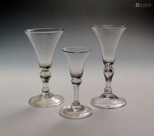 Two light baluster wine glasses c.1730, with bell bowls raised on inverted baluster stems