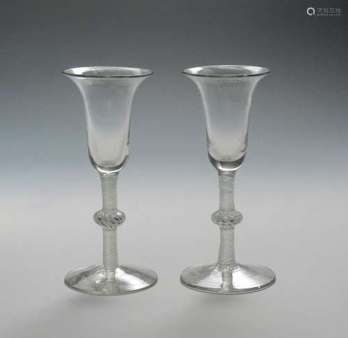 A pair of Dutch wine glasses c.1770, the bell bowls raised on knopped opaque twist stems, 17cm. (2)