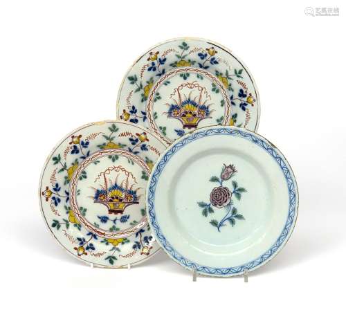 A pair of Delft plates 18th century, painted in polychrome enamels with baskets of fruit and