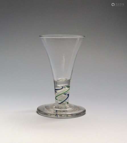 A rare colour twist firing glass c.1770, the drawn trumpet bowl rising from a short stem enclosing a