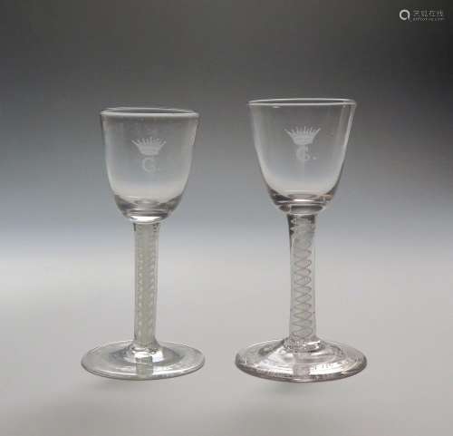 A pair of wine glasses c.1770, one English, one Dutch, the round funnel bowls later engraved with