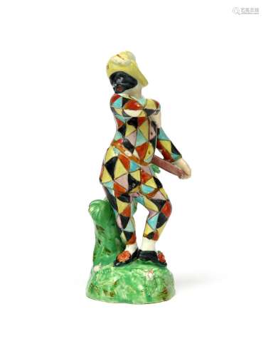 A pearlware figure of Harlequin early 19th century, modelled after Derby, wearing a typical