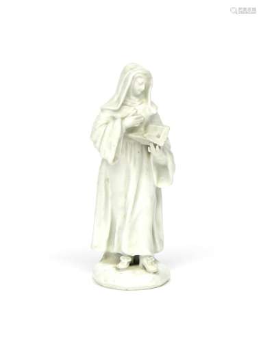 A Bow white-glazed figure of a nun c.1755, standing and reading from a prayer book held in her
