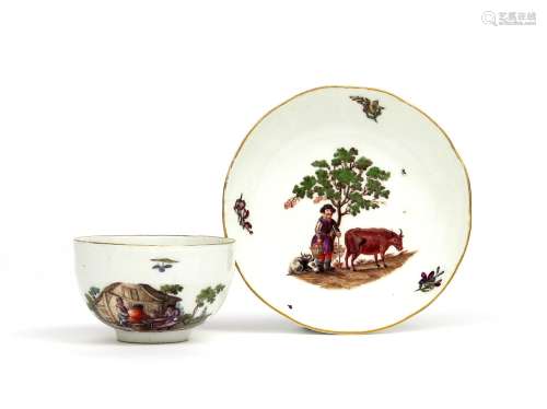 A Meissen tea cup and saucer c.1760, the saucer painted with a farmhand with his stock beneath a