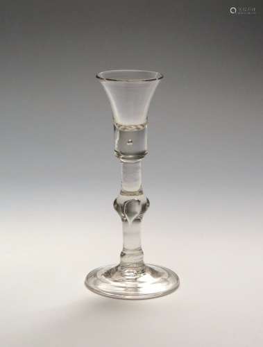 A baluster cordial glass c.1715, the short waisted bucket bowl rising from a thick base with