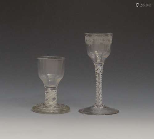 A small wine glass c.1765, the ogee bowl engraved with a continuous formal border, on a double