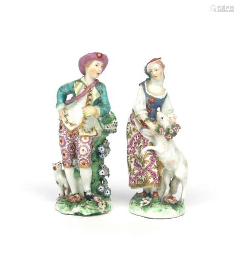 A pair of Chelsea figures of a shepherd and shepherdess c.1760-65, he leaning on a flowering stump