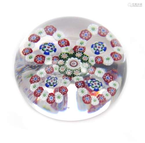 A Baccarat spaced paperweight c.1850, set with a four-petalled flowerhead formed from rings of