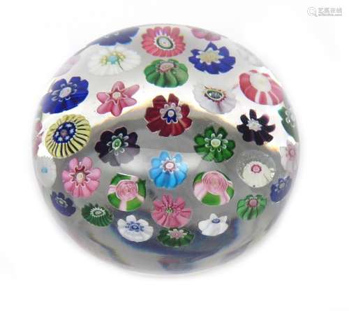 A large Clichy spaced paperweight c.1850, set with a variety of colourful canes including two Clichy