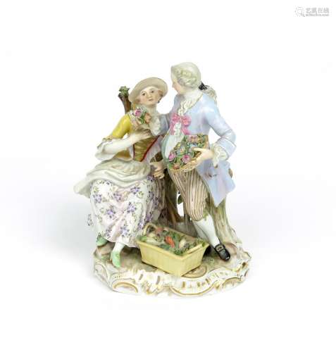 A Meissen pastoral figure group 19th century, a gardener offering a small posy of flowers to his