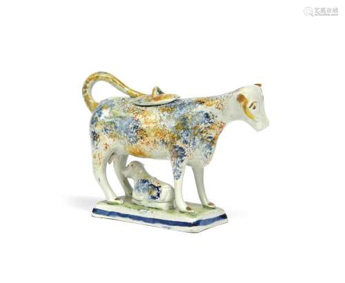 A small Pratt ware cow creamer and cover c.1800, standing four square on a flat rectangular base,