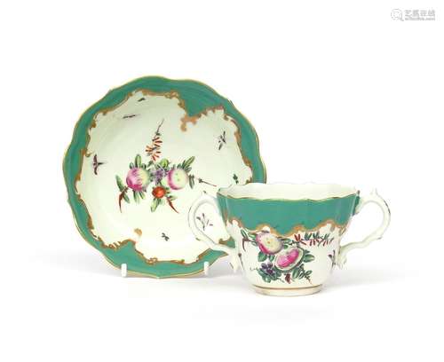 A Worcester two-handled chocolate cup and saucer c.1770, painted with arrangements of spotted fruit,