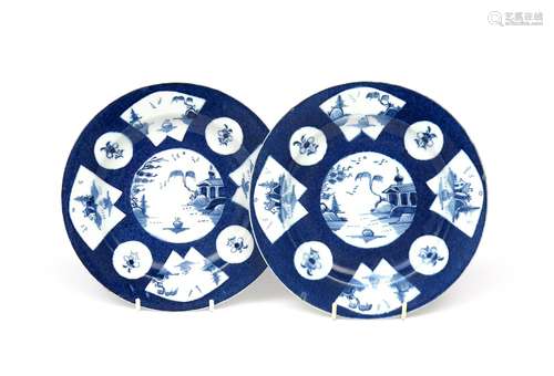 A small pair of Bow blue and white plates c.1760, painted with circular and fan-shaped panels of